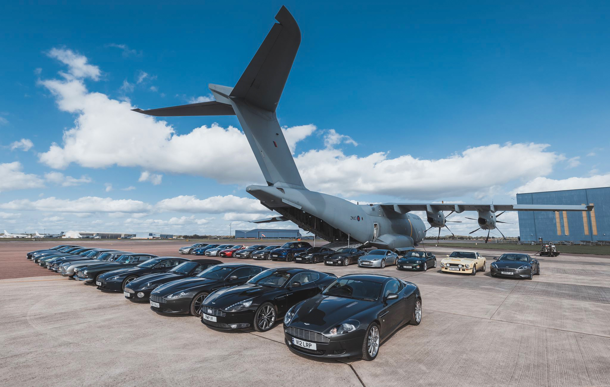 Photo - Aston Martin vehicles lined-up behind an Atlas C Mk.1 (A400M)
